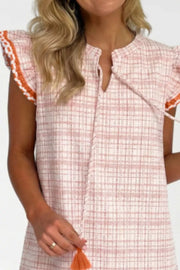Pink plaid shift dress with ruffled trim and tassel detail