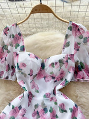 White floral midi dress with puff sleeves and ruffle hem
