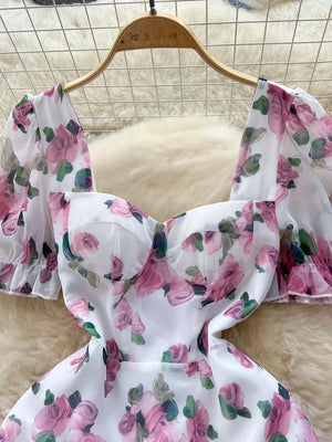 White floral midi dress with puff sleeves and ruffle hem