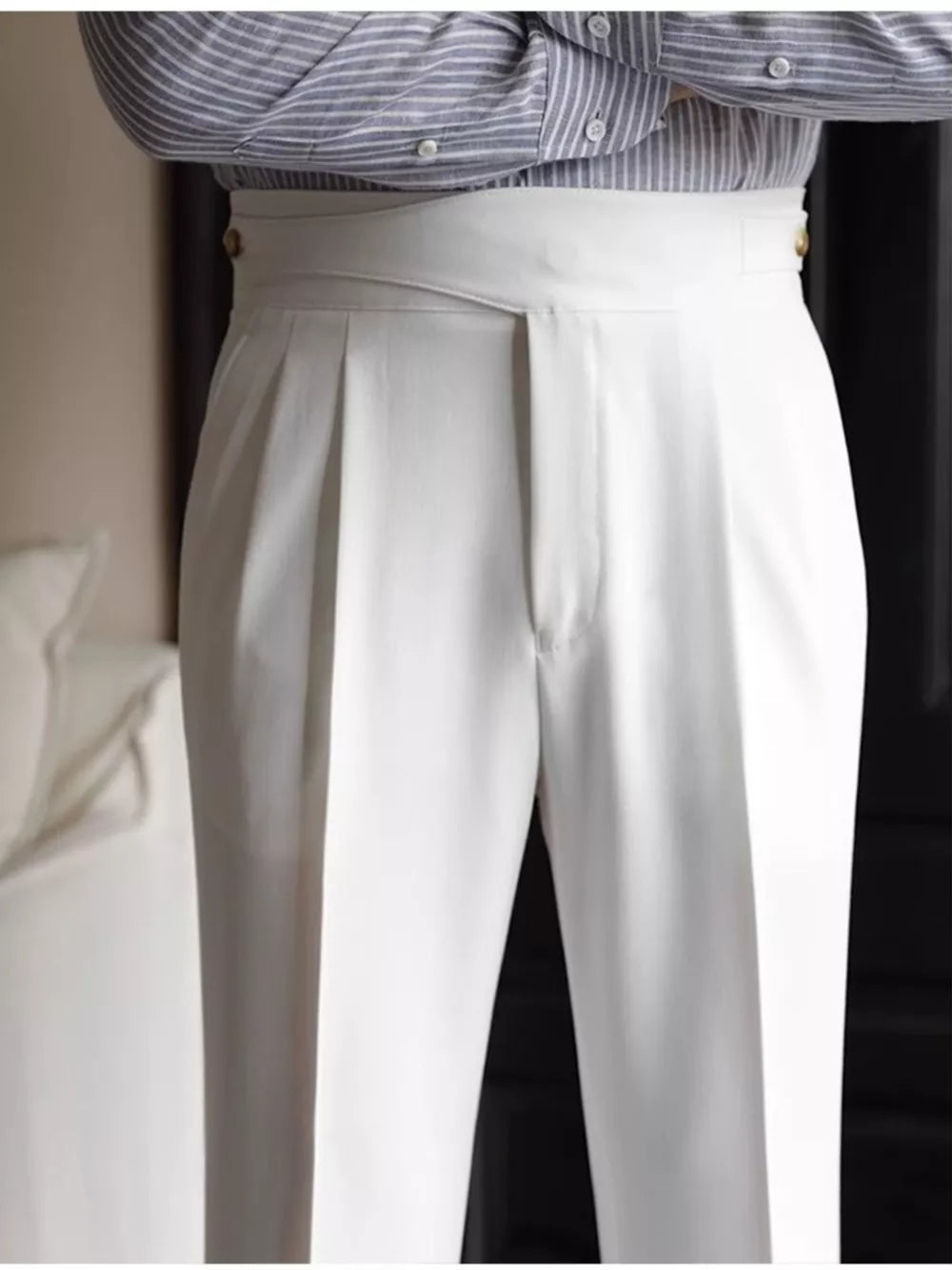 White pleated wide-leg dress pants with a high waist and button details.