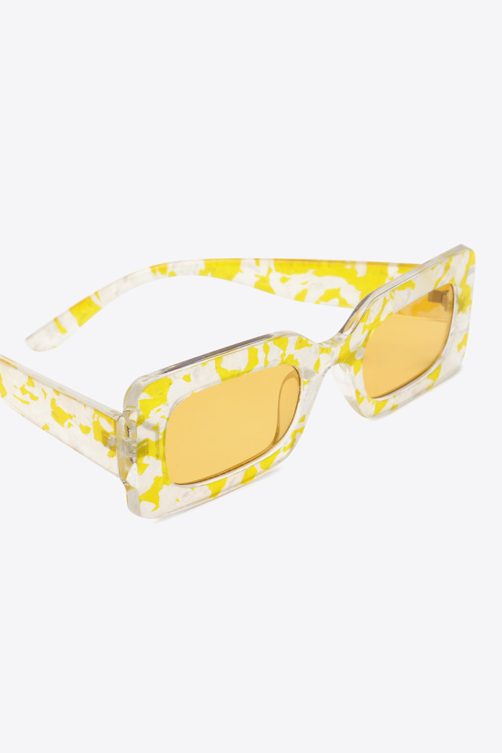 Rectangular frame sunglasses in Butter Yellow with a swirl print and amber lenses.