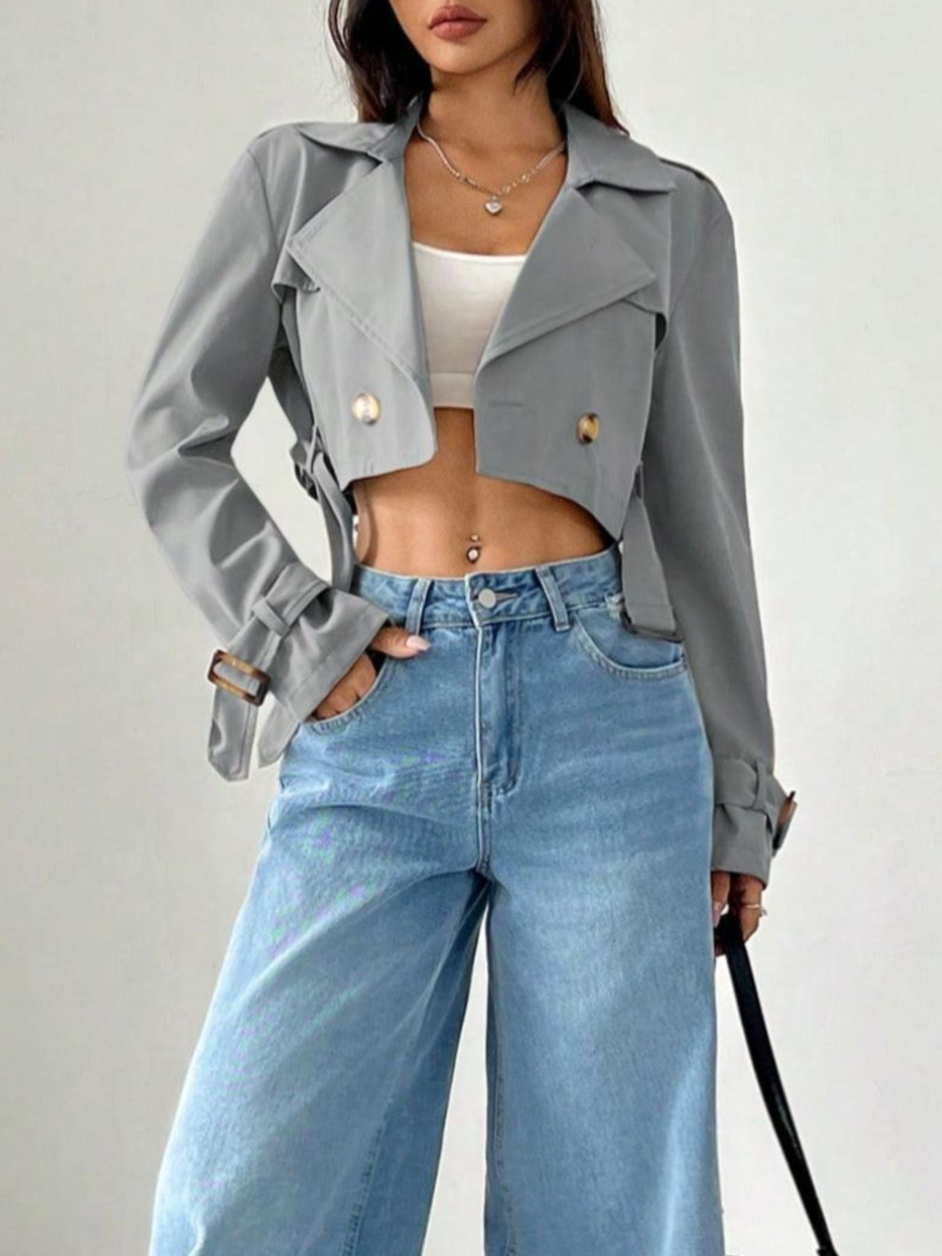 Gray cropped double-breasted trench coat with adjustable cuffs and belt detail.
