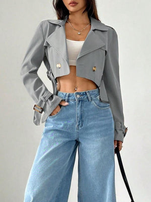 Gray cropped double-breasted trench coat with adjustable cuffs and belt detail.