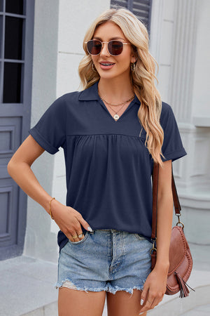Dark Blue polo shirt with gathered yoke, short sleeves, and collar.