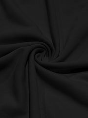 Black cotton t-shirt fabric with a subtle texture, shown in a draped swirl.