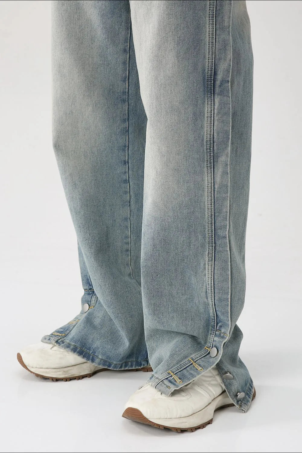 Baggy denim jeans in medium wash with side snap hem detail