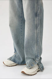 Baggy denim jeans in medium wash with side snap hem detail