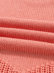 Burnt coral knit sweater with detailed texture and subtle open knit pattern.