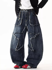 Dark wash wide leg jeans with star patchwork and distressed frayed details.