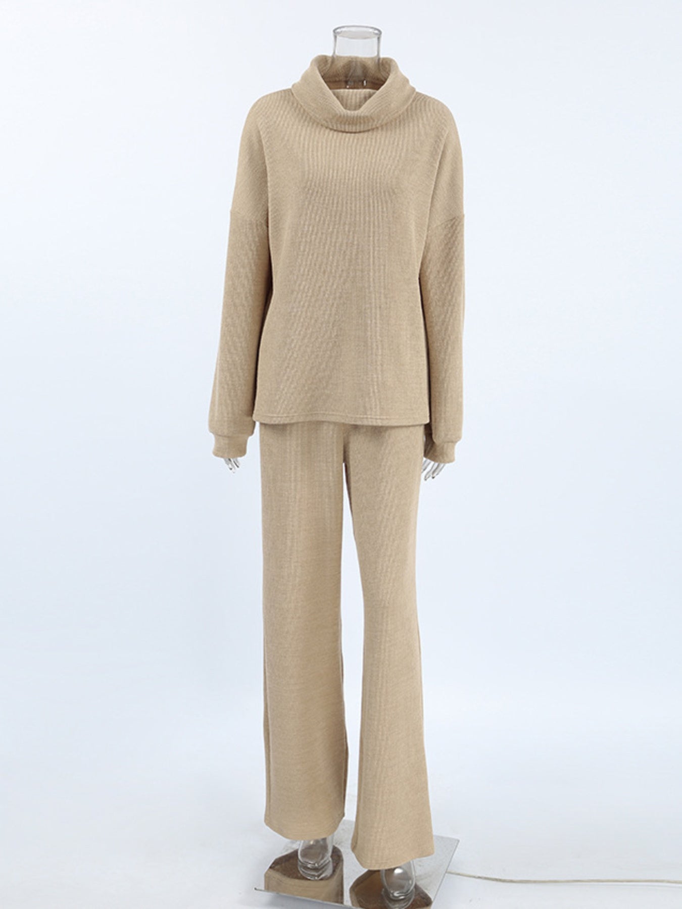 Beige cowl-neck turtleneck sweater and wide-leg pants set with ribbed texture.