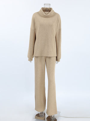 Beige cowl-neck turtleneck sweater and wide-leg pants set with ribbed texture.