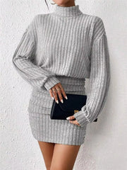 Light gray ribbed turtleneck mini dress with long sleeves and ruched waist detail.