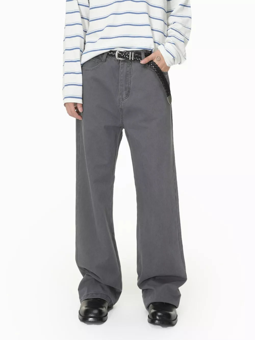 Men's relaxed fit grey cotton jeans with button closure and braided belt.
