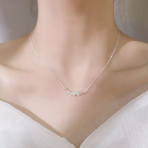 Silver necklace with delicate ginkgo leaf charm and sparkling stones