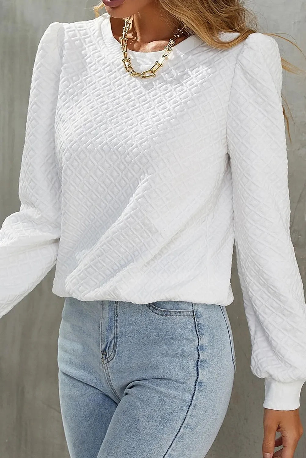 White textured puff sleeve crewneck pullover sweater with a diamond pattern.