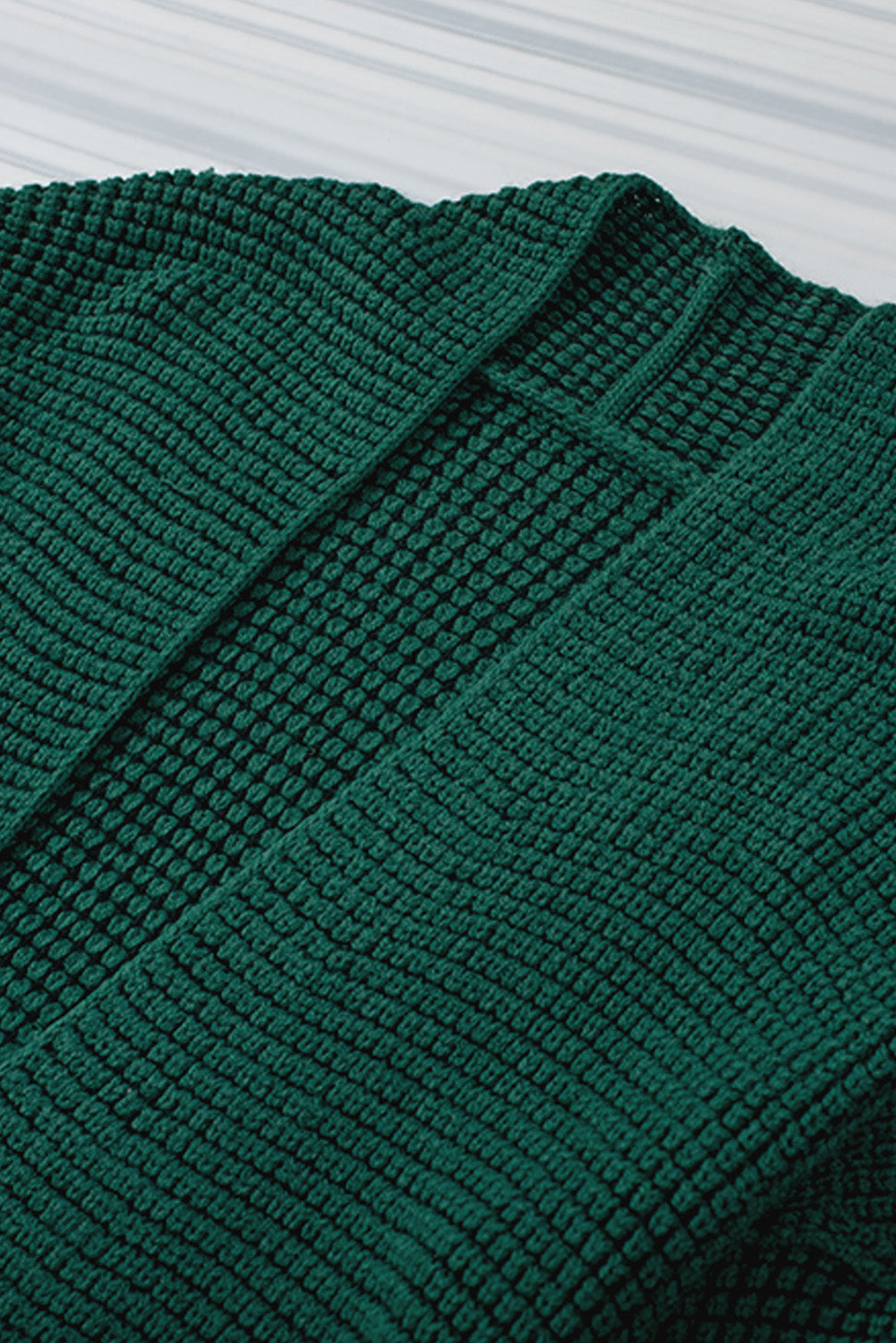 Textured open cardigan in Black Forest acrylic with a waffle knit pattern.