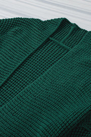 Textured open cardigan in Black Forest acrylic with a waffle knit pattern.