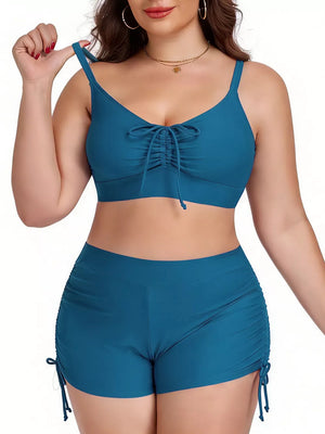 Plus size Peacock Blue adjustable swimwear set with drawstring tie-front top and ruched shorts.