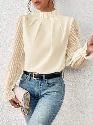 Cream chevron sleeve ruffle neck blouse with sheer sleeves and ruffled cuffs.