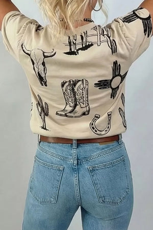 Cream crew neck t-shirt with western graphic print including bull skull, boots, cactus, horseshoe and sun symbol.