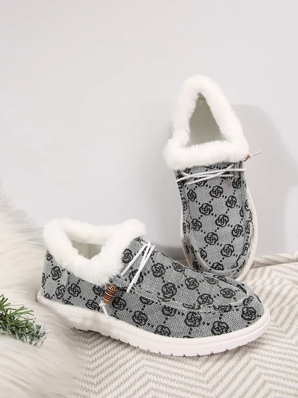 Gray Southwestern print faux fur lined loafers with white laces and wooden bead detail.
