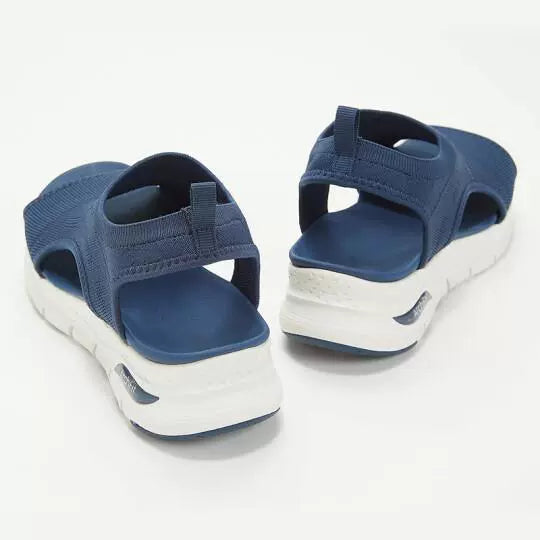 Blue breathable open-toe wedge sandals with a chunky white sole.