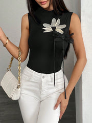 Black ribbed mock neck sleeveless top with floral appliqué and bow detail