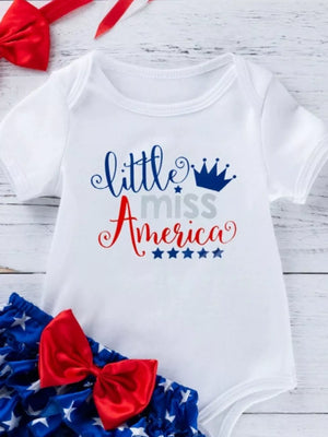 White baby onesie with patriotic "little miss America" graphic and star print bloomer with red bow.