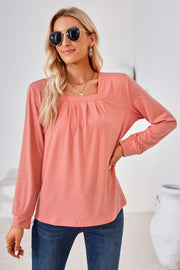 Burnt Coral jersey top with gathered square neckline and long sleeves.