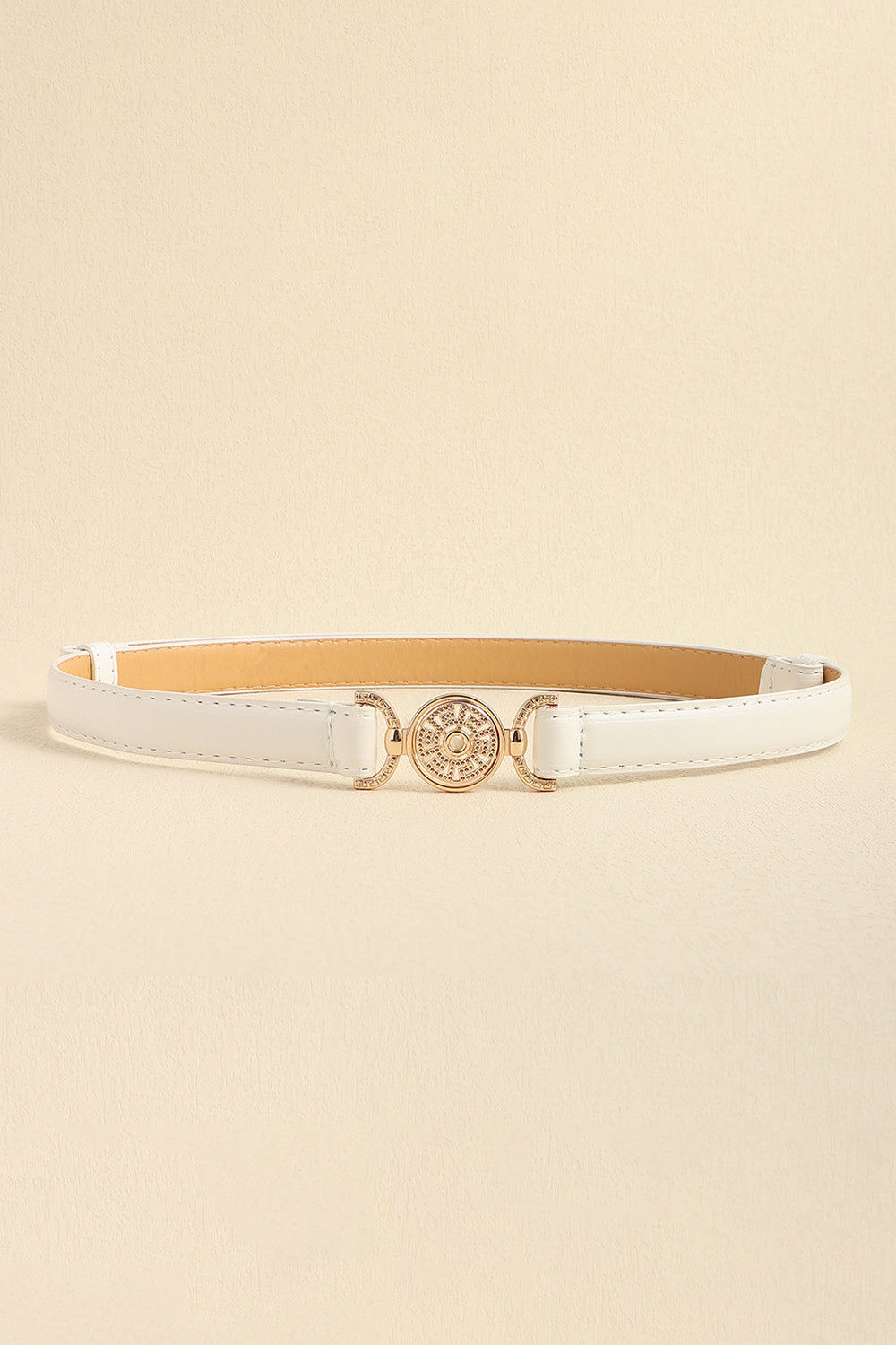 White leather belt with gold circular embellished buckle and adjustable strap