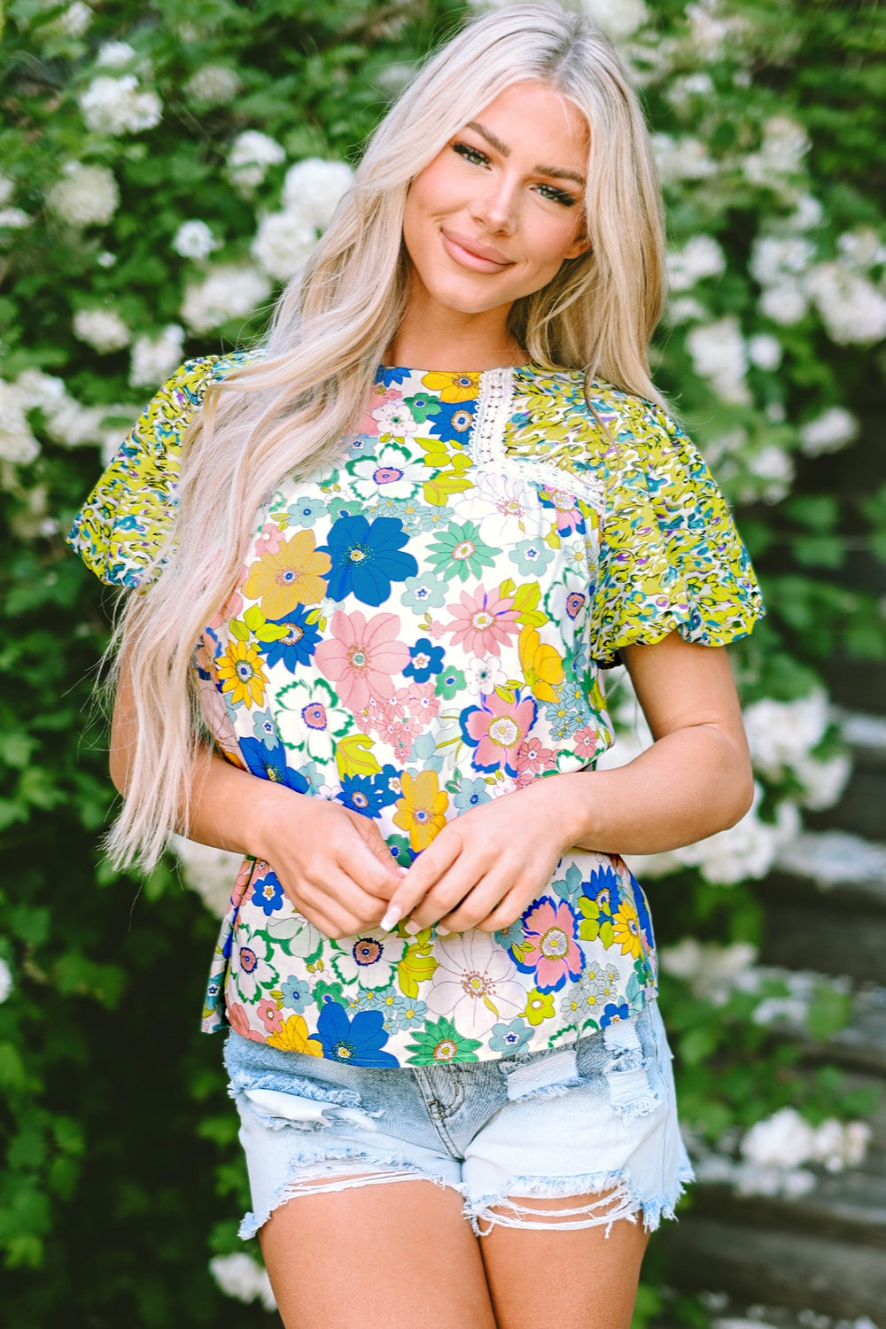 Floral patchwork puff sleeve blouse with crochet trim and mixed floral prints.