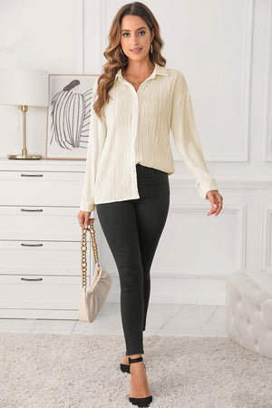 Beige pleated texture oversized button-down shirt with a collared neckline and long sleeves.