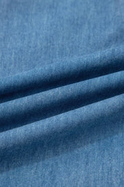 Chambray maternity jeans in a light wash denim with a wide-leg cut and ruffled hem detail.