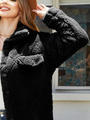Black quilted teddy bear coat with patch pockets and button front.