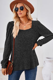 Black ribbed square neck top with puffed sleeves and a relaxed fit.