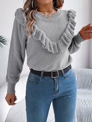 Gray knit sweater with textured yoke and ruffled detail.