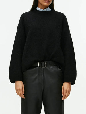 Black oversized brushed knit crewneck sweater with textured knit and relaxed fit.