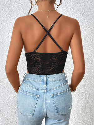 Black lace bodysuit with crisscross straps and a keyhole detail, styled with jeans.