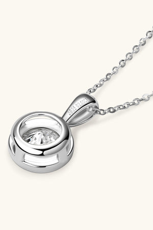 Silver solitaire bezel pendant necklace with a clear stone and delicate chain.