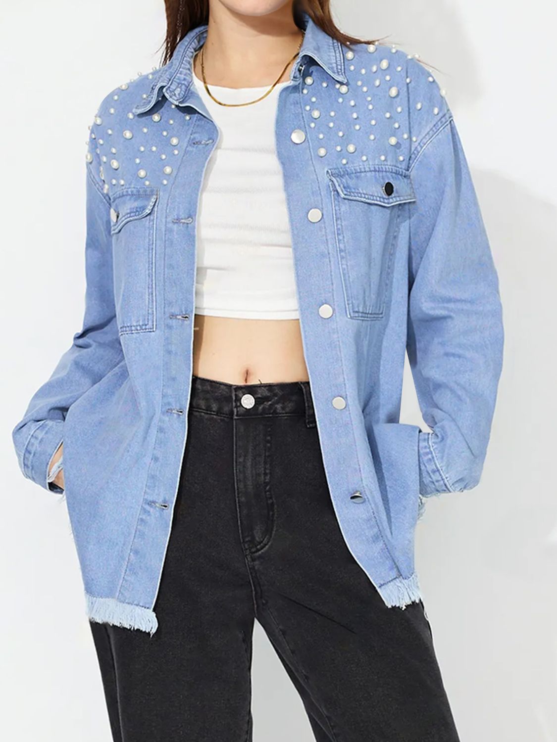 Pearl-embellished light wash denim shirt with frayed hem and collar.
