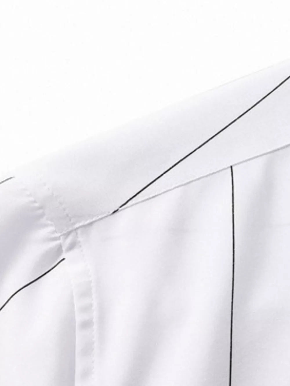 White cotton oversized pinstripe button-down shirt detail showing collar and stitching.