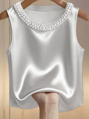 White satin tank top with pearl embellished neckline.