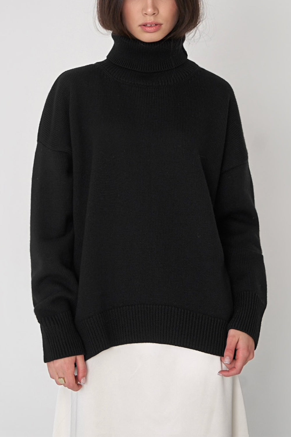 Black relaxed roll-neck sweater with boxy fit and ribbed details.