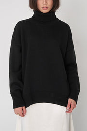 Black relaxed roll-neck sweater with boxy fit and ribbed details.
