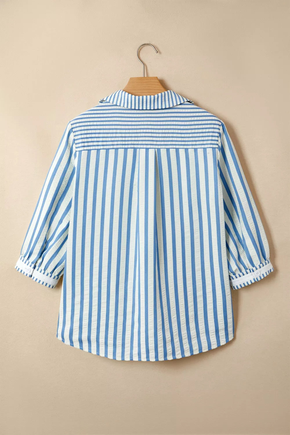 Blue and white striped cotton collared blouse with smocked yoke and cuffed sleeves.