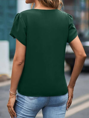 Dark green lace trim flutter sleeve blouse with a V-neck, styled with jeans.
