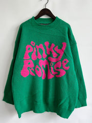 Green knit jumper with pink "Pinky Promise" graphic, crew neck, long sleeves.