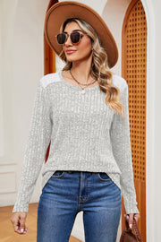 Light gray ribbed knit top with eyelet shoulder detail and crew neck.