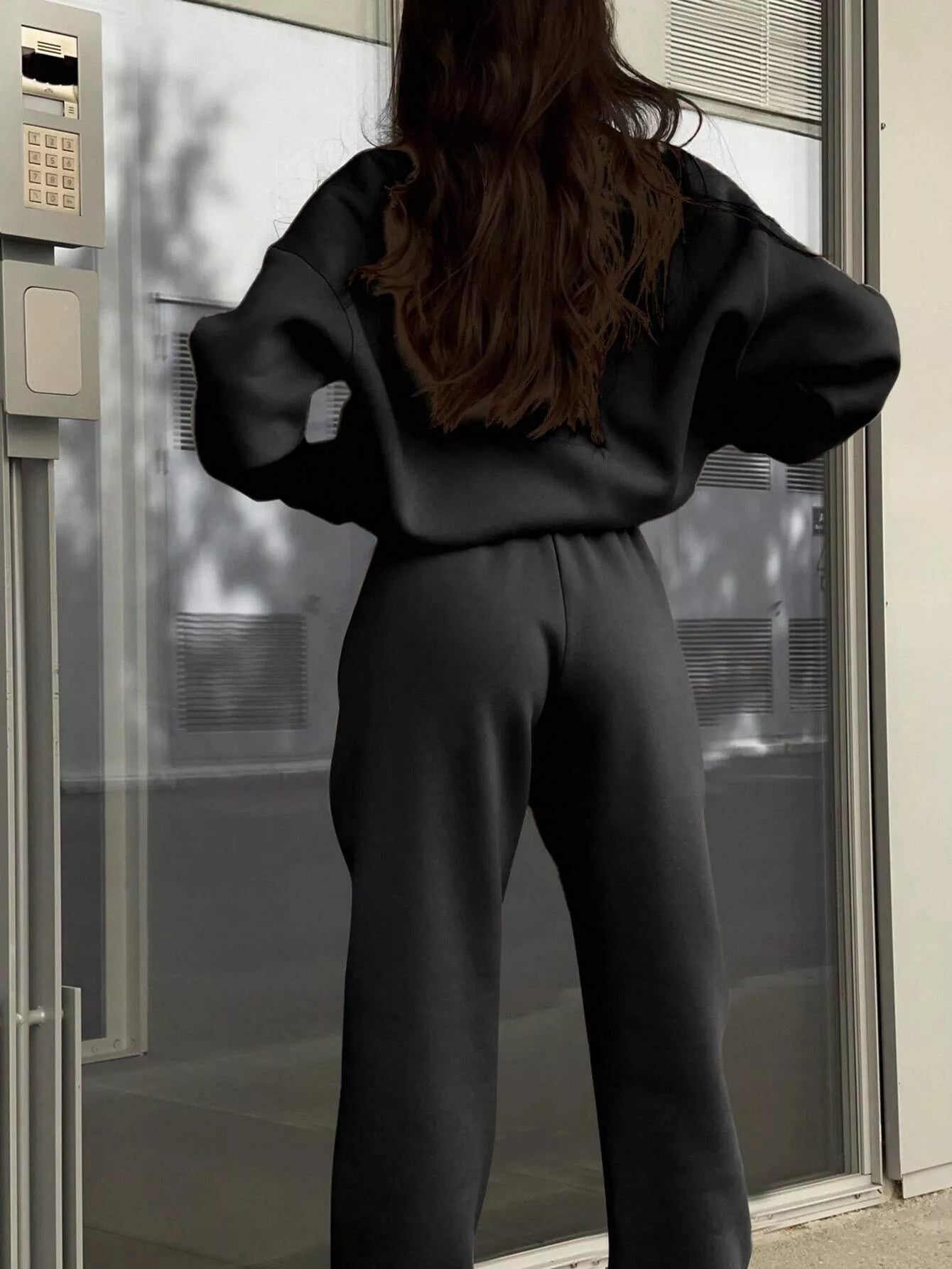 Black half zip sweatshirt and matching pants set, comfortable athleisure outfit.