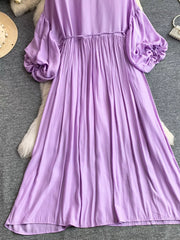 Purple bohemian maxi dress with balloon sleeves and gathered cuffs, polyester fabric.